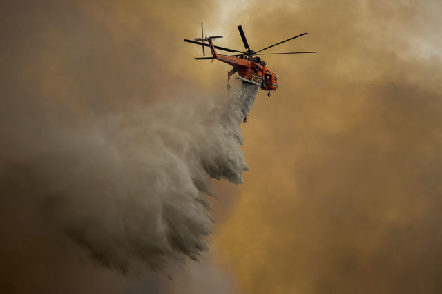 Wildfires across US West force thousands to flee their homes