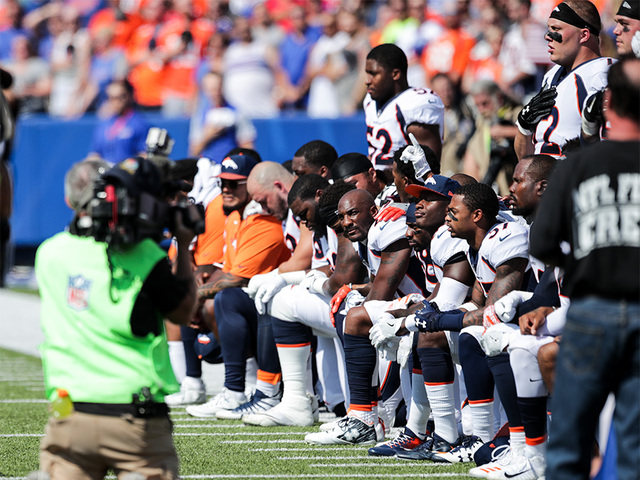 In photos: Broncos kneel, lock arms and raise fists after Trump's remarks